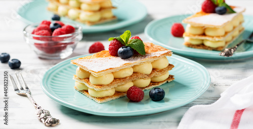 Classic french dessert millefeuille with vanilla cream and fresh berries. photo