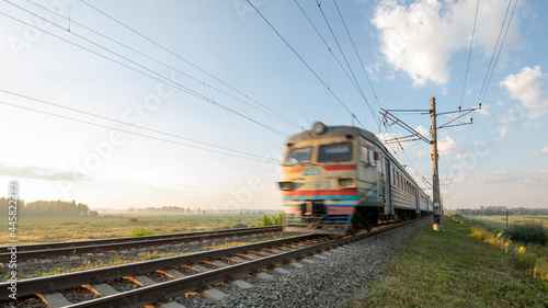 A passenger train on the railway is moving at high speed