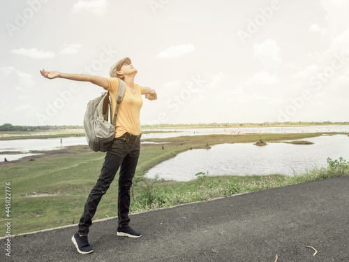 Asian woman standing looking up at the sky happy mood focus on women