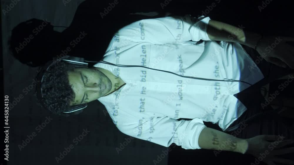 An adult Hispanic man filming a music video with visual effects in a studio An adult Hispanic man filming a music video with visual effects in a studio
