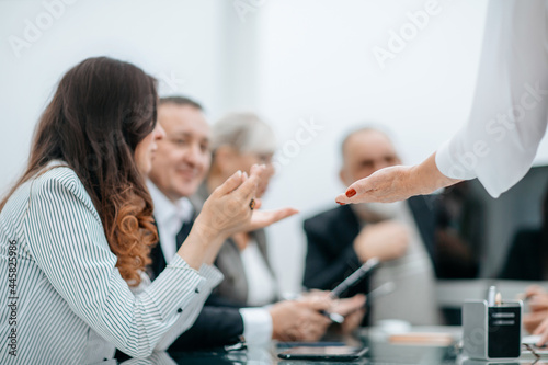 working group discussing business documents at a working meeting