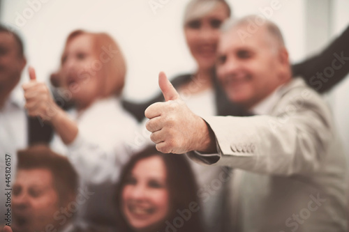 close up. background image of business people with thumbs up.