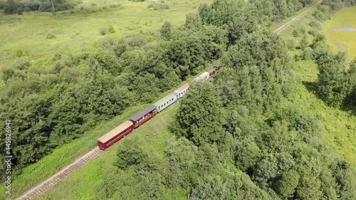 Aerial view of a small train that rides among the trees (Kirovo-Chepetsk, Russia) photo