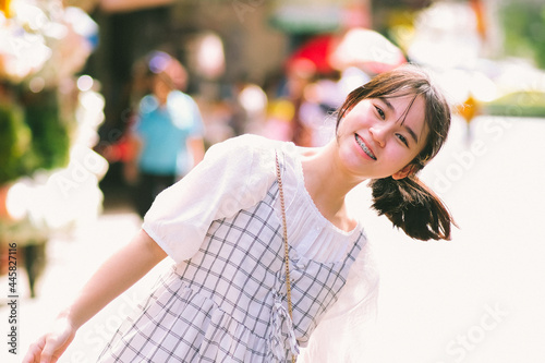 Portrait of teenager girl happy walking on city streets, 