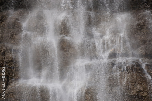closeup of a waterfall on the rocks on a windy day  in the moutains of the alps  france