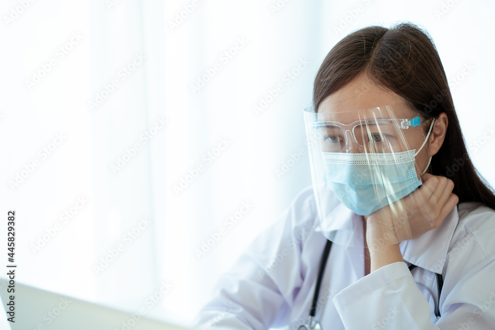 Asian female doctor using laptop computer for working in hospital. Asian female doctor using laptop computer for working in hospital.