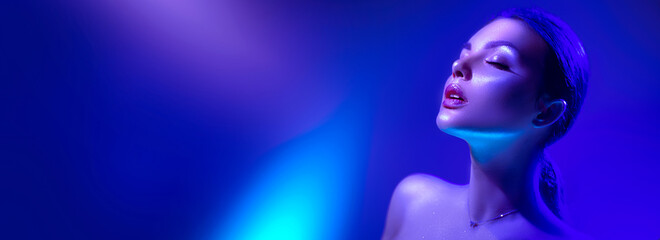 High Fashion model woman in colorful bright neon lights posing in studio, night club. Portrait of beautiful girl in UV. Art design colorful make up. On colourful vivid background, art design. 