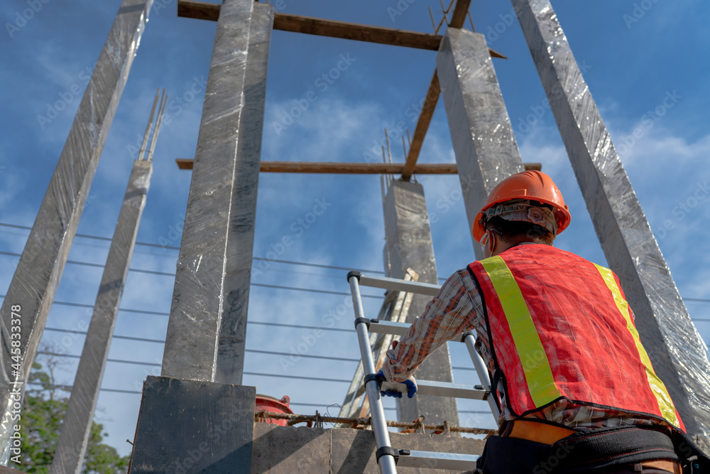 Backside worker in uniform at the construction site Backside worker in uniform at the construction site