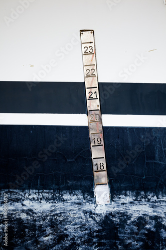 Part of the hull with a waterline and freight marks, closeup. photo