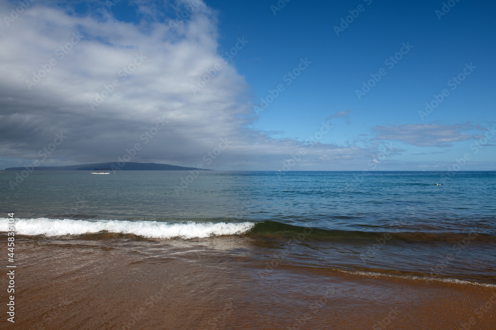 Seaside view of beach, summer vacation background. Surf splashing tide.