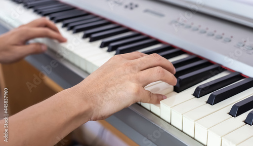 Musician playing piano and the hands on the piano keys