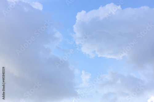 Sun rays shine through a thick cummulus cloud. Blue sky with white clouds. perfect for sky replacements