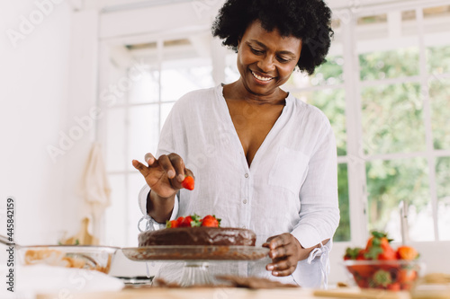 Obraz na plátně African female preparing delicious cake at home