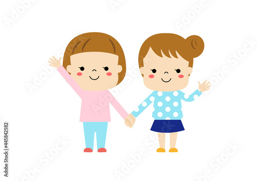 手をつないで手を振っている二人の女の子
