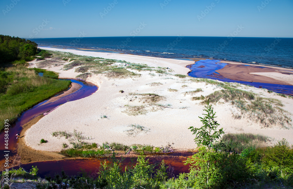 The small freshwater Peterupe river flows into the Baltic Sea near the White Dune in Saulkrasti, Latvia