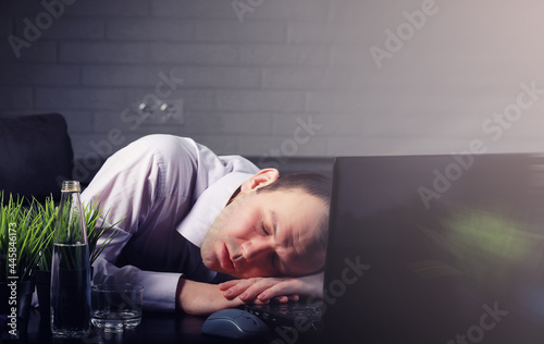 man at table and working on laptop © alexkich