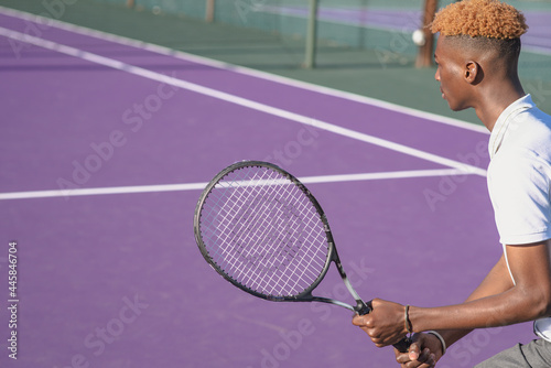 Young man shot from behind while playing tennis © rushay