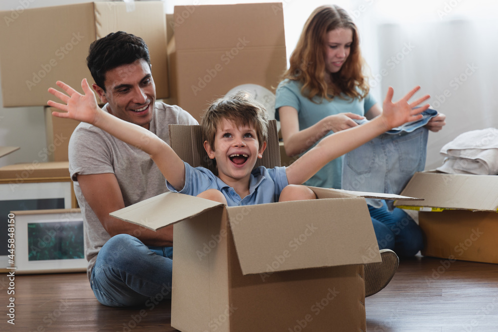 Parents and children sit floor Unpacking During move new home. Parents and children sit floor Unpacking During move new home.