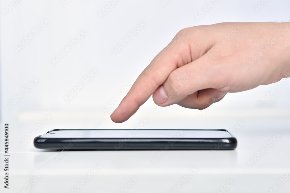 Hand using smartphone on white background. Hand using smartphone on white background.