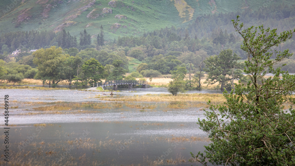 A landscape view of flooded land adjacent to Derwent Water, the Lake District, UK