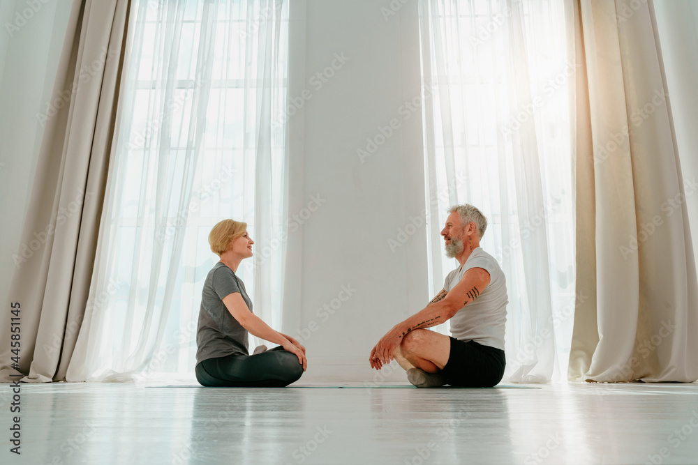 Husband and wife do yoga exercise together at home Husband and wife do yoga exercise together at home