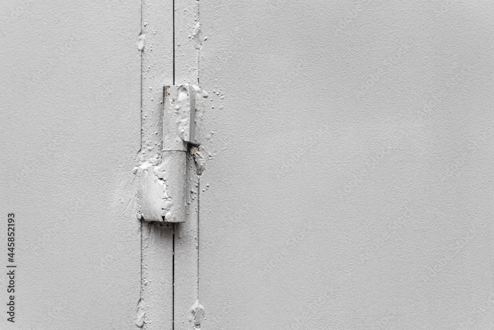 Hinge on painted gray metal gate close-up Hinge on painted gray metal gate close-up