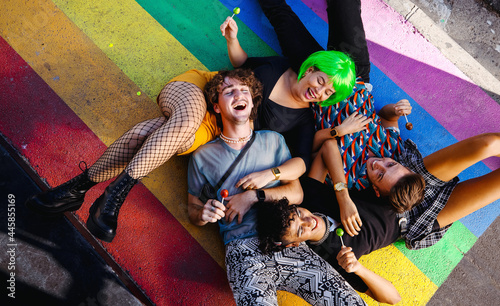 Four young queer people lying down together photo