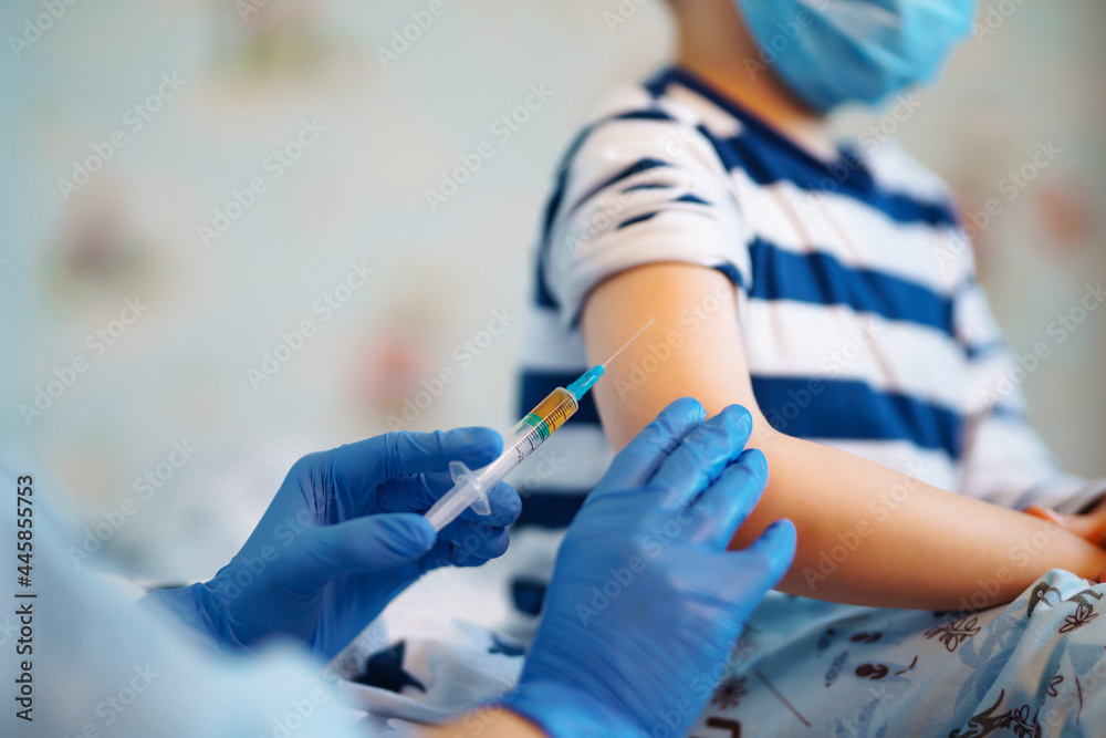 Fototapeta premium People vaccination concept for immunity health. Covid-19. Children's doctor vaccinating little boy at home. Healthcare, coronavirus, prevention and immunize.