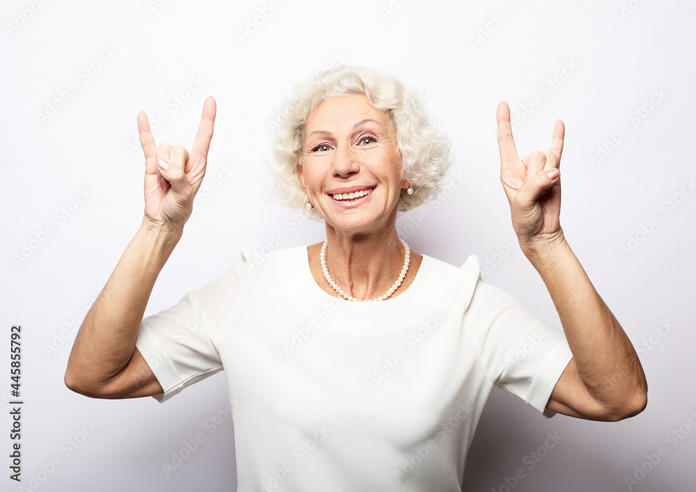idea, attention and people concept - portrait of smiling senior woman pointing finger up over white background idea, attention and people concept - portrait of smiling senior woman pointing finger up over white background
