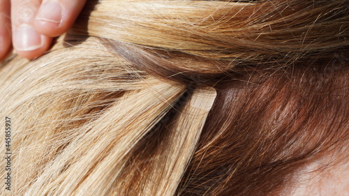  hair extensions in blond girl, womans hair, professional from hairdresser, tape in extensions