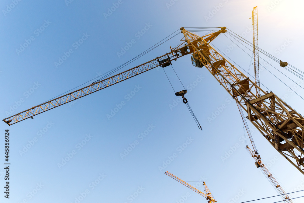 Construction crane. Huge crane against blue sky. Self-erection cranr. Tower crane. Construction crane. Huge crane against blue sky. Self-erection cranr. Tower crane.