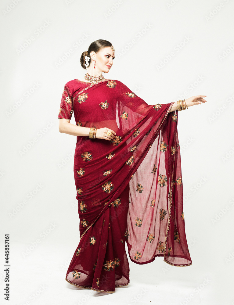 indian woman in traditional clothing dancing over white background