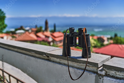 Binoculars on the viewpoint on the background of red roof tile houses at Sighnaghi city of love, Kakheti region, Georgia country