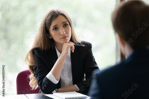 Engaged young recruiter, recruit agent talking to job candidate on interview. Client consulting manager, banker lawyer in office. Business woman, broker, advisor listening to customer on meeting