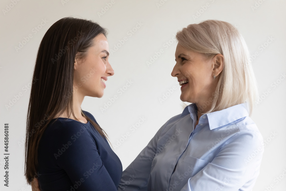 Happy affectionate loving senior mother and grownup daughter talking, hugging and laughing. Mature mom and grown child enjoying time together. Family generations, relationship, visiting parents Happy affectionate loving senior mother and grownup daughter talking, hugging and laughing. Mature mom and grown child enjoying time together. Family generations, relationship, visiting parents