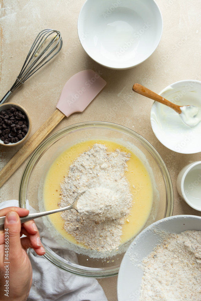 Mixing ingredients for cooking cake or muffins in glass bowl, top view. Step by step recipe. Mixing ingredients for cooking cake or muffins in glass bowl, top view. Step by step recipe.