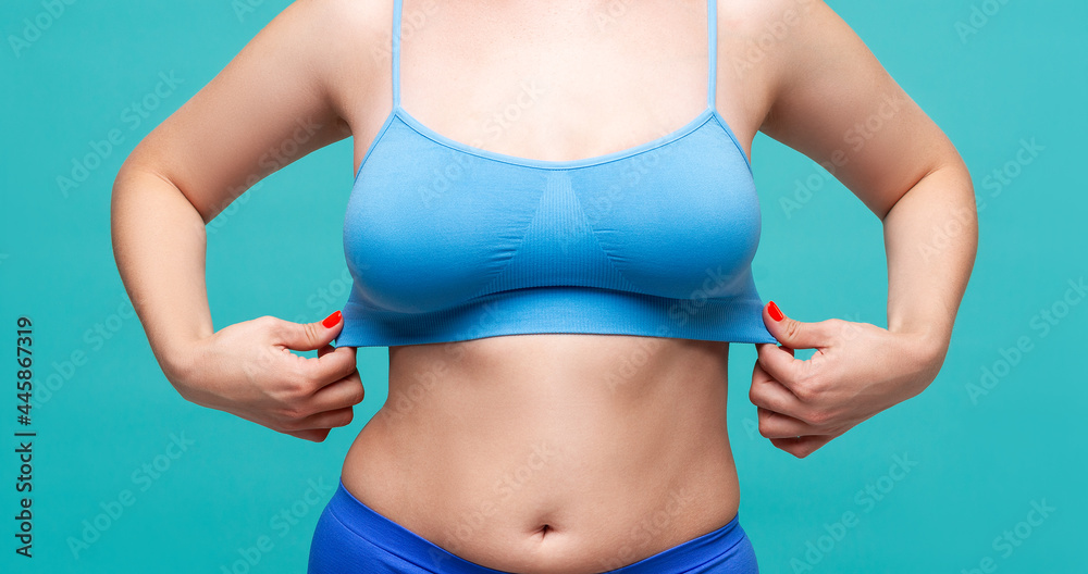 Woman in blue top bra with big natural breasts on turquoise background  Stock Photo | Adobe Stock