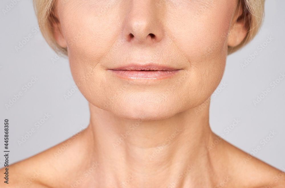 Close-up, concept without face, the bottom third of the face of a Caucasian mature beautiful woman. Close-up, concept without face, the bottom third of the face of a Caucasian mature beautiful woman.