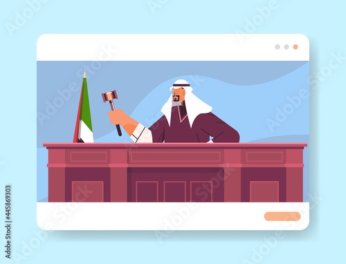 arab judge lawyer procurator in uniform with gavel sitting at workplace online court session law process