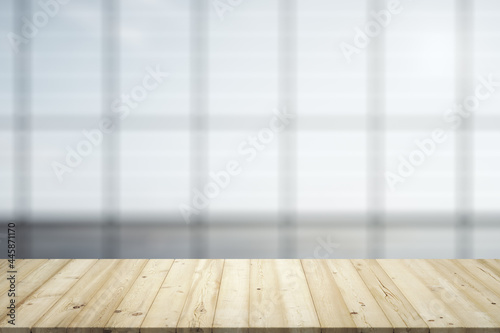 Blank wooden desk with light empty office room with big window on background, mockup © Pixels Hunter