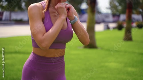 Athletic girl working out in green park