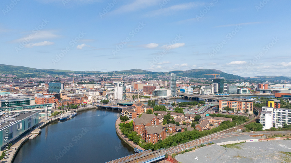 Fototapeta premium Aerial view on river and buildings in City center of Belfast Northern Ireland. Drone photo, high angle view of town