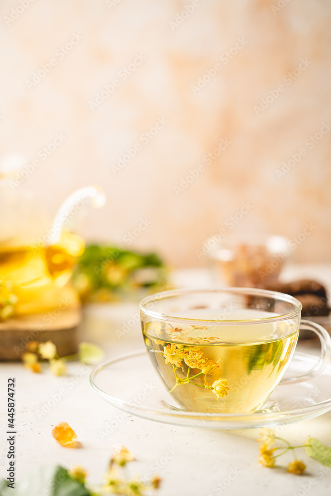 Cup of herbal tea with linden flowers on white background Cup of herbal tea with linden flowers on white background