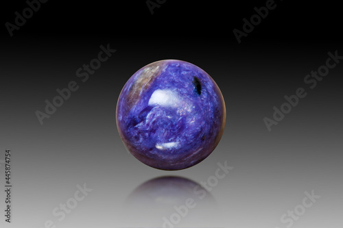 Natural charoite round polished cabochon gemstone setting. Looks like a purple violet planet in the universe. Black and white gradient background, semireflection, gauss blur. Gemology theme. Abstract. photo