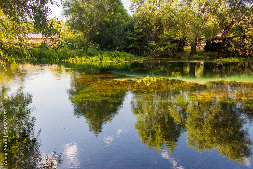 On the banks of the river Tirino. Clear, transparent water. A beautiful landscape in the province of L'Aquila in Abruzzo On the banks of the river Tirino. Clear, transparent water. A beautiful landscape in the province of L'Aquila in Abruzzo