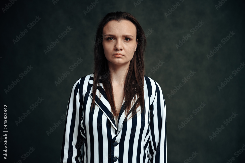 Photo portrait of serious brunette woman on gray background Photo portrait of serious brunette woman on gray background