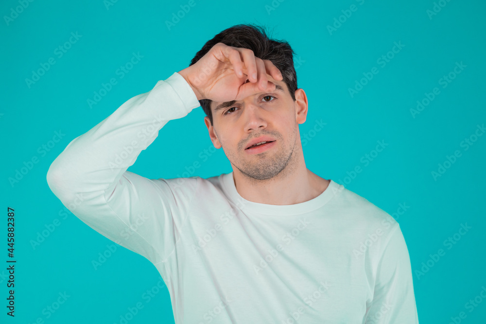 Frustrated european man over teal wall background. Guy is tired, bored of work or studying, he disappointed, helpless Frustrated european man over teal wall background. Guy is tired, bored of work or studying, he disappointed, helpless