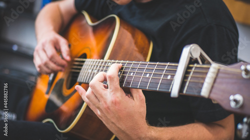 musician playing acoustic guitar