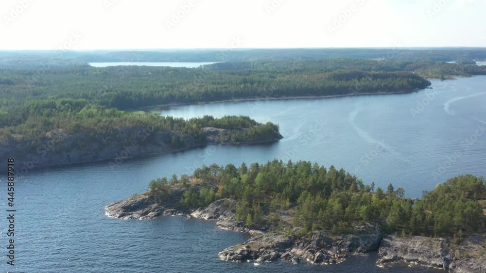Aerial view on the lake and Islands with rocky coastline and forest in Karelia. Drone view on the beautiful Ladoga lake. Skerriy in the northwestern part of the Lake Ladoga Aerial view on the lake and Islands with rocky coastline and forest in Karelia. Drone view on the beautiful Ladoga lake. Skerriy in the northwestern part of the Lake Ladoga