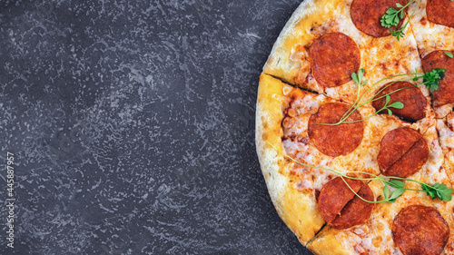 close-up pepperoni pizza on concrete surface, top view, place for copy space